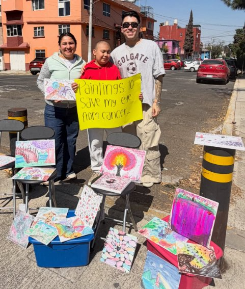 Arlett selling her paintings on the street to fund her eye surgery