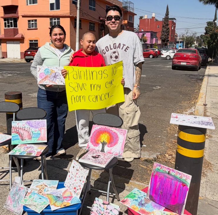Isaiah Garza with Arlett and her mother selling paintings on the street